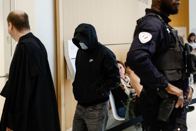An after-school club leader at a primary school accused of allegedly sexually assaulting minors arrives in court for his trial at the Paris courthouse, in Paris on May 5, 2026. The 47-year-old youth worker at a Parisian school stands trial in the first case of violence in after-school programs since the scandal broke in the French capital. He is appearing in court on charges of allegedly sexually harassing nine girls and sexually assaulting three of them, offenses that carry a potential sentence of up to ten years in prison and a fine of 150,000. (Photo by Kenzo TRIBOUILLARD / AFP)