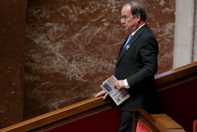French Socialist party (PS) MP Francois Hollande leaves during a session of questions to the government at the National Assembly, French Parliament's lower house, in Paris on May 5, 2026. (Photo by Thomas SAMSON / AFP)