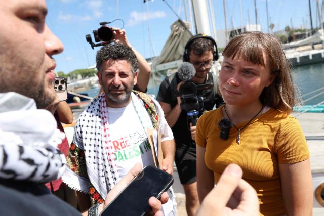 (FILES) Swedish climate activist Greta Thunberg (R) and Spanish activist Saif Abu Keshek (C) talk to members of the media as a flotilla carrying humanitarian aid and activists prepare to leave for Gaza, in Barcelona on August 30, 2025. Spain on April 5, 2026 renewed a demand for the "immediate release" of a Spanish activist who participated in a Gaza-bound aid flotilla and is held in Israel after his detention was extended until April 10, 2026. Spain's consul in Tel Aviv will continue to visit Saif Abu Keshek, "providing full protection and in permanent contact with his family", foreign ministry sources said. "The government of Spain demands his immediate release and that all his rights be respected." (Photo by LLUIS GENE / AFP)