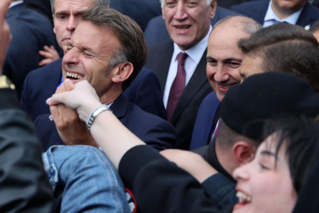 France's President Emmanuel Macron is greeted by people in Gyumri on May 5, 2026. (Photo by Ludovic MARIN / AFP)