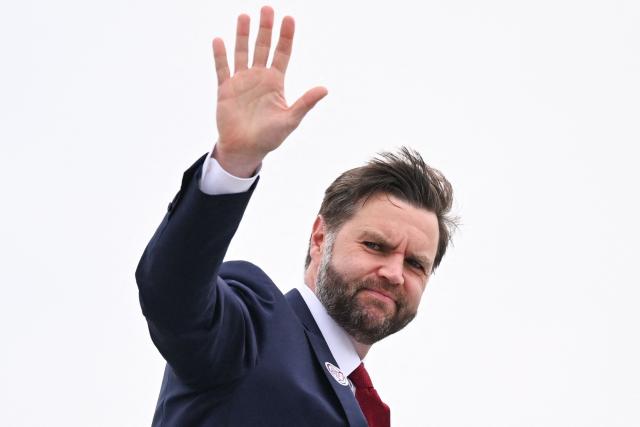 US Vice President JD Vance waves as he boards Air Force Two as he departs from Cincinnati/Northern Kentucky International Airport in Hebron, Kentucky on May 5, 2026. Vance stopped in Ohio to vote in the state's primary election before continuing on to Oklahoma and Iowa. (Photo by Roberto Schmidt / POOL / AFP)
