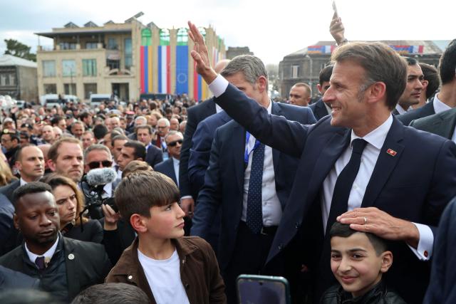 France's President Emmanuel Macron greets the crowd in Gyumri on May 5, 2026. (Photo by Ludovic MARIN / AFP)