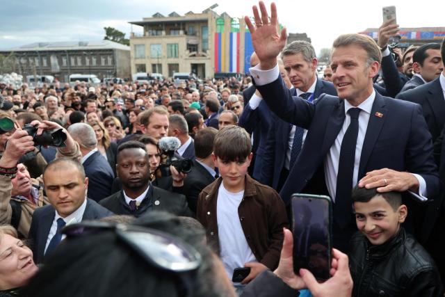 France's President Emmanuel Macron greets the crowd in Gyumri on May 5, 2026. (Photo by Ludovic MARIN / AFP)