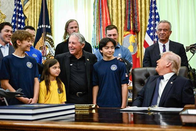 US President Donald Trump speaks before signing a proclamation to revive the Presidential Fitness Test Award, a competitive school-based fitness program, in the Oval Office of the White House in Washington, DC on May 5, 2026. Also pictured, at center left (in black blazer), is South African retired golfer Gary Player. (Photo by Kent NISHIMURA / AFP)