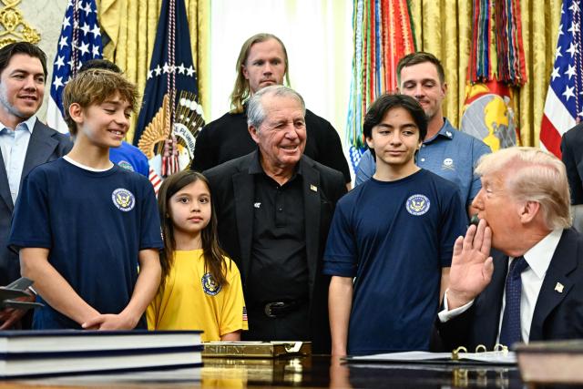 South African retired golfer Gary Player (C) looks on as US President Donald Trump speaks before signing a proclamation to revive the Presidential Fitness Test Award, a competitive school-based fitness program, in the Oval Office of the White House in Washington, DC on May 5, 2026. (Photo by Kent NISHIMURA / AFP)