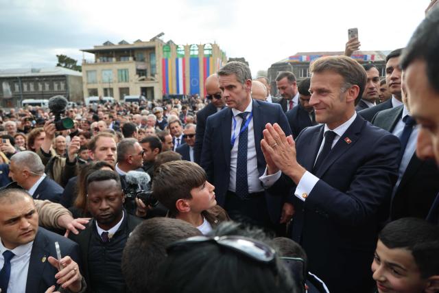 France's President Emmanuel Macron greets the crowd in Gyumri on May 5, 2026. (Photo by Ludovic MARIN / AFP)