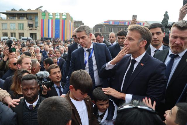 France's President Emmanuel Macron greets the crowd in Gyumri on May 5, 2026. (Photo by Ludovic MARIN / AFP)