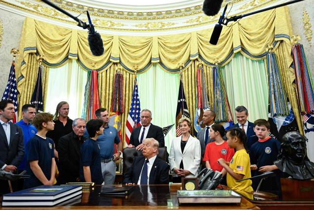 US Secretary of Health and Human Services Robert F. Kennedy Jr. (C) speaks before President Donald Trump signs a proclamation to revive the Presidential Fitness Test Award, a competitive school-based fitness program, in the Oval Office of the White House in Washington, DC on May 5, 2026. (Photo by Kent NISHIMURA / AFP)