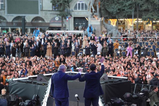 France's President Emmanuel Macron acknowledges the crowd after a concert before leaving Gyumri on May 5, 2026. (Photo by Ludovic MARIN / AFP)