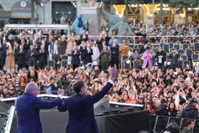 France's President Emmanuel Macron, accompanied by Armenia's Prime Minister Nikol Pashinyan, acknowledges the crowd after a concert before leaving Gyumri on May 5, 2026. (Photo by Ludovic MARIN / AFP)