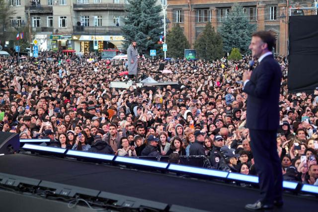 France's President Emmanuel Macron acknowledges the crowd after a concert before leaving Gyumri on May 5, 2026. (Photo by Ludovic MARIN / AFP)