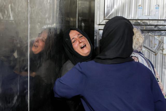 Relatives of Palestinian child Mahmoud Sahwil, 14, who was killed during an Israeli strike on a police station in the Sheikh Radwan neighbourhood, react as they mourn at the morgue at Shifa Hospital in Gaza City on May 5, 2026. (Photo by Omar AL-QATTAA / AFP)