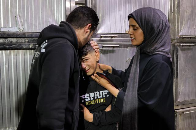 Relatives of Palestinian child Mahmoud Sahwil, 14, who was killed during an Israeli strike on a police station in the Sheikh Radwan neighbourhood, react as they mourn at the morgue at Shifa Hospital in Gaza City on May 5, 2026. (Photo by Omar AL-QATTAA / AFP)