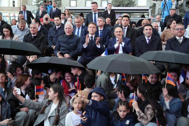 France's President Emmanuel Macron, accompanied by Armenia's Prime Minister Nikol Pashinyan and Armenia's President Vahagn Khachaturyan, attends a concert in Gyumri on May 5, 2026. (Photo by Ludovic MARIN / AFP)