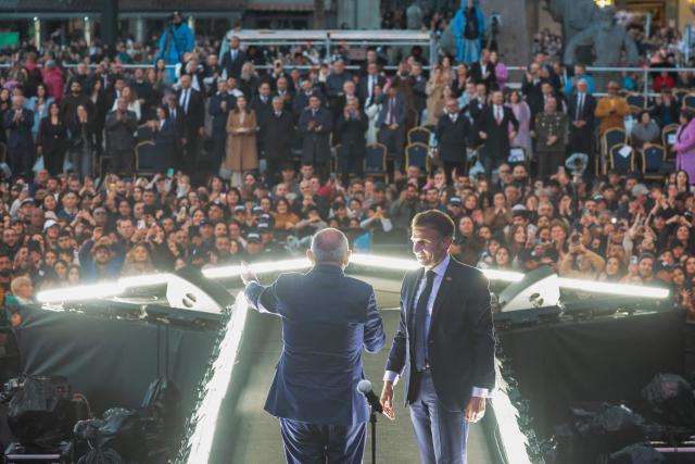 France's President Emmanuel Macron, accompanied by Armenia's Prime Minister Nikol Pashinyan, acknowledges the crowd after a concert before leaving Gyumri on May 5, 2026. (Photo by Ludovic MARIN / AFP)
