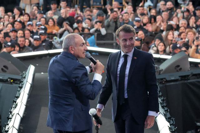 France's President Emmanuel Macron, accompanied by Armenia's Prime Minister Nikol Pashinyan, acknowledges the crowd after a concert before leaving Gyumri on May 5, 2026. (Photo by Ludovic MARIN / AFP)