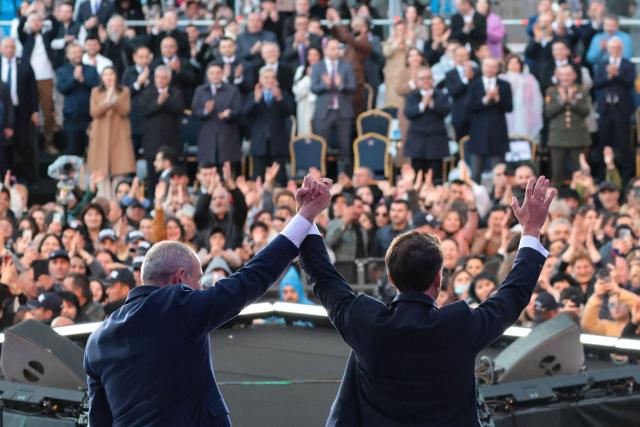 France's President Emmanuel Macron, accompanied by Armenia's Prime Minister Nikol Pashinyan, acknowledges the crowd after a concert before leaving Gyumri on May 5, 2026. (Photo by Ludovic MARIN / AFP)