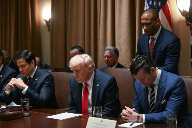 (FILES) US President Donald Trump bows his head in prayer alongside Secretary of State Marco Rubio, Secretary of Defense Pete Hegseth and House and Urban Development Secretary Scott Turner during a cabinet meeting at the White House in Washington, DC, on February 26, 2025. In February, Pentagon chief Pete Hegseth invited Christian nationalist pastor Doug Wilson, who opposes women voting or serving in combat roles, to preach at the Defense Department.
Six months earlier, Hegseth attended the first service of a new church planted in Washington by Wilson's small, ultra-conservative denomination based out of Moscow, Idaho, called the Communion of Reformed Evangelical Churches (CREC). (Photo by Jim WATSON / AFP)