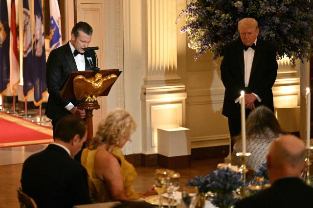 (FILES) Defense Secretary Pete Hegseth (L) conducts a prayer as US President Donald Trump (R) listens during a dinner with state governors in the East Room of the White House in Washington, DC, on February 21, 2026. In February, Pentagon chief Pete Hegseth invited Christian nationalist pastor Doug Wilson, who opposes women voting or serving in combat roles, to preach at the Defense Department.
Six months earlier, Hegseth attended the first service of a new church planted in Washington by Wilson's small, ultra-conservative denomination based out of Moscow, Idaho, called the Communion of Reformed Evangelical Churches (CREC). (Photo by Mandel NGAN / AFP)
