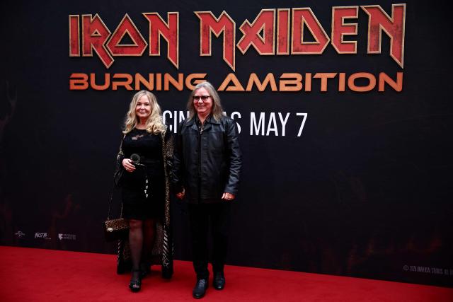 Dave Murray of Iron Maiden and his wife Tamar Murrray pose on the red carpet upon arrival to attend the world premiere of 'Iron Maiden: Burning Ambition' at Cineworld Leicester Square, in central London on May 5, 2026. (Photo by Henry NICHOLLS / AFP)
