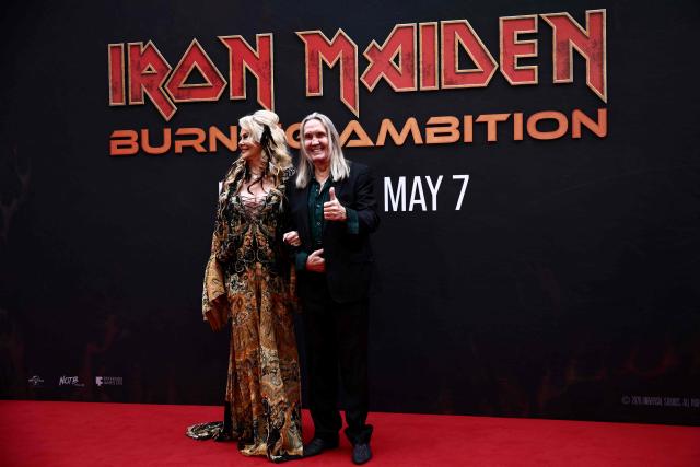 Nicko McBrain of Iron Maiden and his wife Rebecca McBrain pose on the red carpet upon arrival to attend the world premiere of 'Iron Maiden: Burning Ambition' at Cineworld Leicester Square, in central London on May 5, 2026. (Photo by Henry NICHOLLS / AFP)
