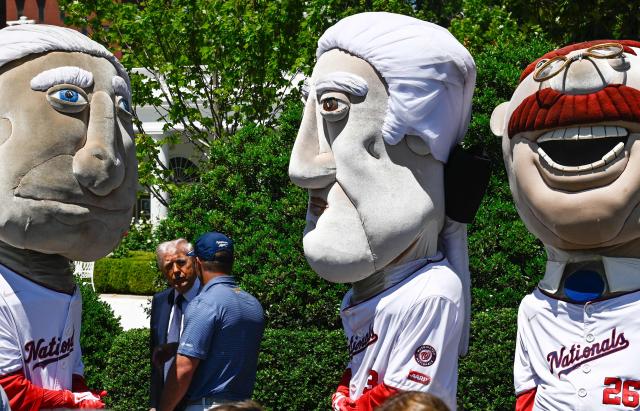 US President Donald Trump speaks with US professional golfer Bryson DeChambeau alongside the Washington Nationals "Racing Presidents" mascots as they attend an event with young student athletes on the South Lawn of the White House after President Trump signed a proclamation to revive the Presidential Fitness Test Award, a competitive school-based fitness program, in Washington, DC on May 5, 2026. (Photo by Kent NISHIMURA / AFP)