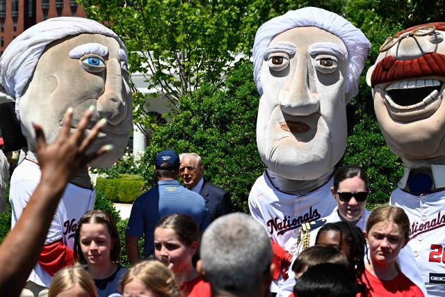 US President Donald Trump speaks with US professional golfer Bryson DeChambeau alongside the Washington Nationals "Racing Presidents" mascots as they attend an event with young student athletes on the South Lawn of the White House after President Trump signed a proclamation to revive the Presidential Fitness Test Award, a competitive school-based fitness program, in Washington, DC on May 5, 2026. (Photo by Kent NISHIMURA / AFP)