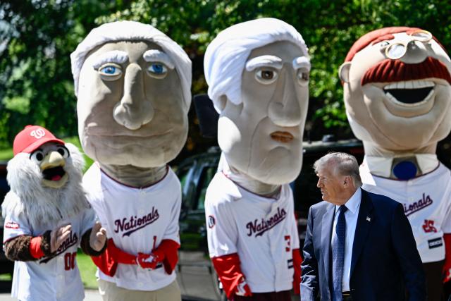 US President Donald Trump walks past the Washington Nationals baseball team's "Racing Presidents" mascots as he arrives to watch young student athletes participate in exercise activities on the South Lawn of the White House after President Trump signed a proclamation to revive the Presidential Fitness Test Award, a competitive school-based fitness program, in Washington, DC on May 5, 2026. (Photo by Kent NISHIMURA / AFP)
