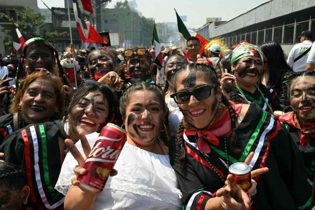 Women pose during the reenactment of the Battle of Puebla, which commemorates the clash between Mexican and French troops in 1862, at Penon de los Banos neighborhood in Mexico City on May 5, 2026. The reenactment of the battle of May 5, 1862, in the town of San Juan de Aragon is a celebration that is part of the cultural identity of its inhabitants. (Photo by YURI CORTEZ / AFP)