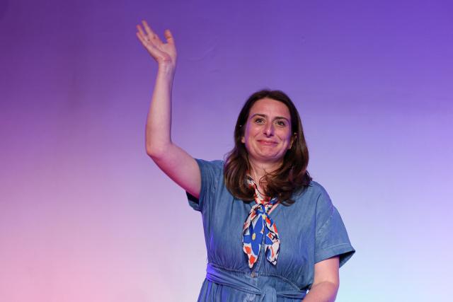 National secretary of French left-wing party The Ecologistes and presidential candidate Marine Tondelier waves as she prepares to deliver a speech during a meeting of the Front Populaire 2027 (Popular Front 2027) initiative, which brings together left-wing parties ahead of France's 2027 Presidential election, in Paris on May 5, 2026. (Photo by Xavier GALIANA / AFP)