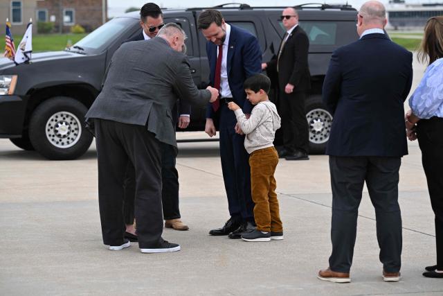 US Vice President JD Vance with his son Vivek by his side, arrives at Des Moines International Airport in Des Moines, Iowa, on May 5, 2026. Vance will speak at Ex-Guard Industries, a manufacturing facility, during a campaign event to support US Representative Zach Nunn, Republican from Iowa. (Photo by Roberto Schmidt / POOL / AFP)