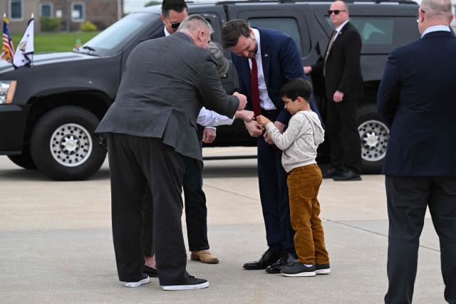 US Vice President JD Vance with his son Vivek by his side, arrives at Des Moines International Airport in Des Moines, Iowa, on May 5, 2026. Vance will speak at Ex-Guard Industries, a manufacturing facility, during a campaign event to support US Representative Zach Nunn, Republican from Iowa. (Photo by Roberto Schmidt / POOL / AFP)
