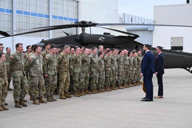 US Vice President JD Vance speaks with members of Iowa Army and Air National Guard at Des Moines International Airport in Des Moines, Iowa, on May 5, 2026. Vance will speak at Ex-Guard Industries, a manufacturing facility, during a campaign event to support US Representative Zach Nunn, Republican from Iowa. (Photo by Roberto Schmidt / POOL / AFP)