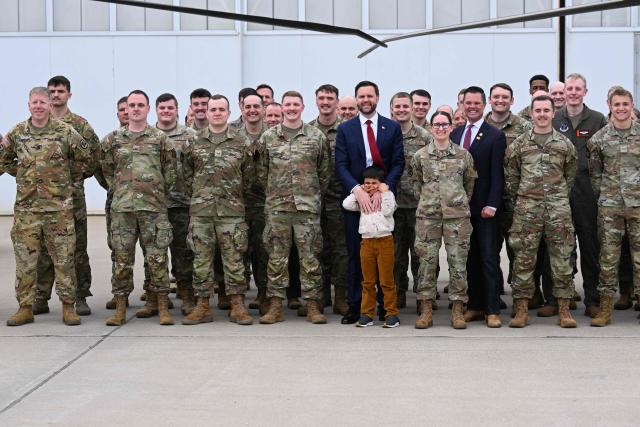 US Vice President JD Vance and his son Vivek takes photos with members of Iowa Army and Air National Guard at Des Moines International Airport in Des Moines, Iowa, on May 5, 2026. Vance will speak at Ex-Guard Industries, a manufacturing facility, during a campaign event to support US Representative Zach Nunn, Republican from Iowa. (Photo by Roberto Schmidt / POOL / AFP)