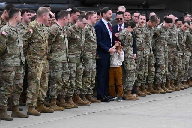 US Vice President JD Vance and his son Vivek takes photos with members of Iowa Army and Air National Guard at Des Moines International Airport in Des Moines, Iowa, on May 5, 2026. Vance will speak at Ex-Guard Industries, a manufacturing facility, during a campaign event to support US Representative Zach Nunn, Republican from Iowa. (Photo by Roberto Schmidt / POOL / AFP)
