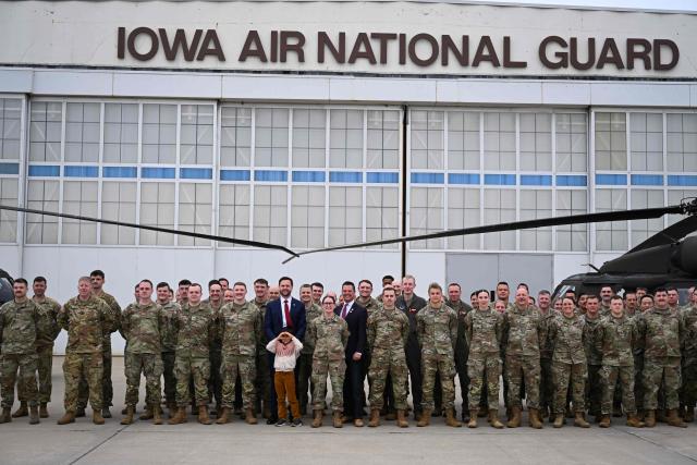 US Vice President JD Vance and his son Vivek takes photos with members of Iowa Army and Air National Guard at Des Moines International Airport in Des Moines, Iowa, on May 5, 2026. Vance will speak at Ex-Guard Industries, a manufacturing facility, during a campaign event to support US Representative Zach Nunn, Republican from Iowa. (Photo by Roberto Schmidt / POOL / AFP)