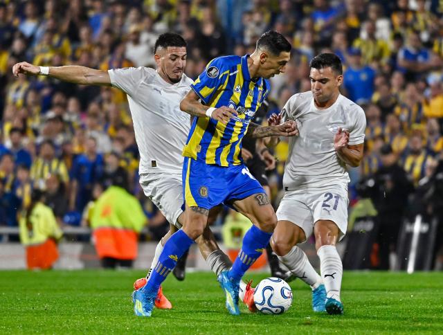 Rosario Central's forward #11 Angel di Maria fights for the ball with Libertad's midfielders #06 Alvaro Campuzano and #21 Lucas Sanabria during the Copa Libertadores group stage football match between Argentina's Rosario Central and Paraguay's Libertad at the Gigante de Arroyito stadium in Rosario, Santa Fe province, Argentina on May 5, 2026. (Photo by Marcelo Manera / AFP)