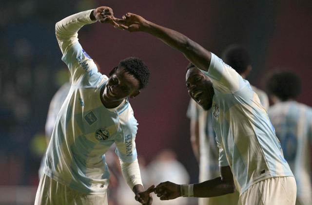 Gremio's Belgian midfielder #09 Francis Amuzu (R) celebrates after scoring his team's second goal with teammate midfielder #37 Gabriel Mec during the Copa Sudamericana group stage football match between Argentina's Deportivo Riestra and Brazil's Gremio at the Pedro Bidegain stadium in Buenos Aires on May 5, 2026. (Photo by JUAN MABROMATA / AFP)