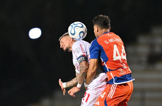 Cienciano's Ecuadorean forward #21 Carlos Garces and Puerto Cabello's defender #44 Geremias Melendez fight for the ball during the Copa Sudamericana group stage football match between Venezuela's Academia Puerto Cabello and Peru's Cienciano at the Misael Delgado stadium in Valencia, state of Carabobo, Venezuela on May 5, 2026. (Photo by Juan BARRETO / AFP)