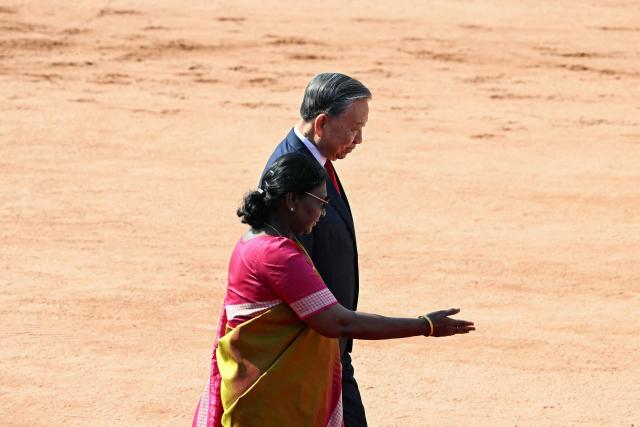 India's President Droupadi Murmu (front) walks with her Vietnamese counterpart To Lam upon his arrival for a ceremonial reception at the presidential palace Rashtrapati Bhavan in New Delhi on May 6, 2026. (Photo by Sajjad HUSSAIN / AFP)