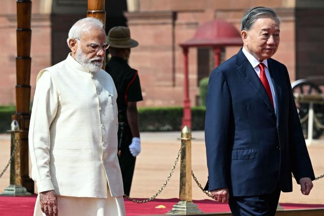 India's Prime Minister Narendra Modi (L) walks with Vietnam's president To Lam during a ceremonial reception at the presidential palace Rashtrapati Bhavan in New Delhi on May 6, 2026. (Photo by Sajjad HUSSAIN / AFP)
