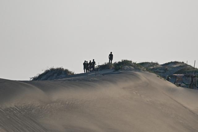Soldiers stand along the sand dunes before the maritime strike of Balikatan exercise between US, Australian, Filipino and Japanese troops in Paoay, Ilocos Norte on May 6, 2026. (Photo by Jam STA ROSA / AFP)