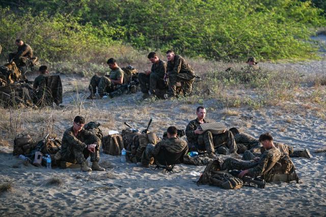 Soldiers rest before the maritime strike of Balikatan exercise between US, Australian, Filipino and Japanese troops in Paoay, Ilocos Norte on May 6, 2026. (Photo by Jam STA ROSA / AFP)
