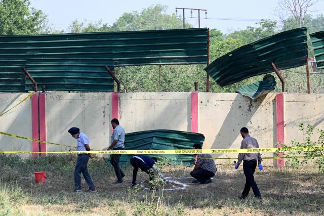 A forensic team inspects the site of a blast near a boundary wall of the Army cantonment area on the outskirts of Amritsar on May 6, 2026. (Photo by Narinder NANU / AFP)