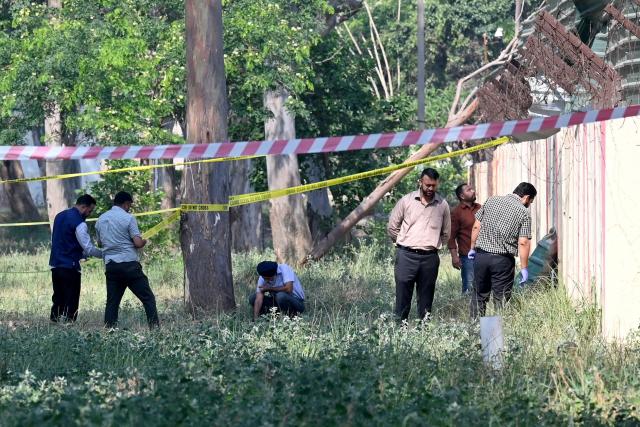 A forensic team inspects the site of a blast near a boundary wall of the Army cantonment area, the night after the explosion on the outskirts of Amritsar on May 6, 2026. (Photo by Narinder NANU / AFP)