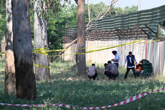 A forensic team inspects the site of a blast near a boundary wall of the Army cantonment area, the night after the explosion on the outskirts of Amritsar on May 6, 2026. (Photo by Narinder NANU / AFP)
