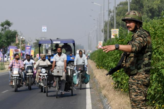An Indian Army personnel diverts traffic near the site of a blast, the night after the explosion at the Army cantonment area on the outskirts of Amritsar on May 6, 2026. (Photo by Narinder NANU / AFP)