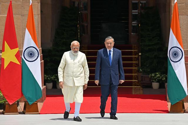 India's Prime Minister Narendra Modi (L) walks with Vietnam's President To Lam before their meeting at the Hyderabad House in New Delhi on May 6, 2026. (Photo by Sajjad HUSSAIN / AFP)