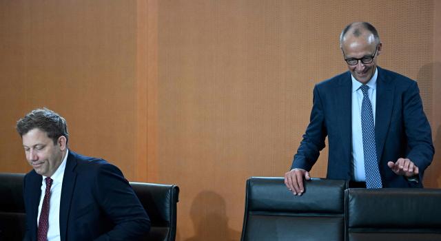 German Chancellor Friedrich Merz (R) walks past German Finance Minister and Vice Chancellor Lars Klingbeil as he arrives for the weekly meeting of the German cabinet at the chancellery in Berlin on May 6, 2026. (Photo by Tobias SCHWARZ / AFP)