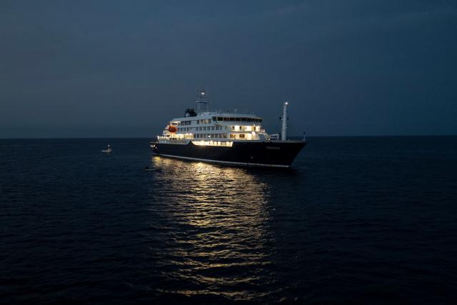 A general view of the cruise ship MV Hondius, while stationary off the port of Praia, the capital of Cape Verde, on May 6, 2026. Two seriously ill crew members on a cruise ship stricken by a deadly hantavirus outbreak will be evacuated via Cape Verde to the Netherlands, allowing the vessel to sail on to Spain's Canary Islands, the ship operator said on May 5, 2026.
The MV Hondius has been at the centre of an international health scare since Saturday, when WHO was informed that the rare disease -- usually spread from infected rodents typically through urine, droppings and saliva -- was suspected of being behind the deaths of three of its passengers.
As others fell ill, passengers and crew have been in isolation after Cape Verde authorities barred the ship from docking, and as health authorities scrambled to find a port that would take the Hondius. (Photo by AFP)